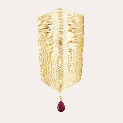 RIPPLE GOLD BANGLE WITH A BURGUNDY STONE